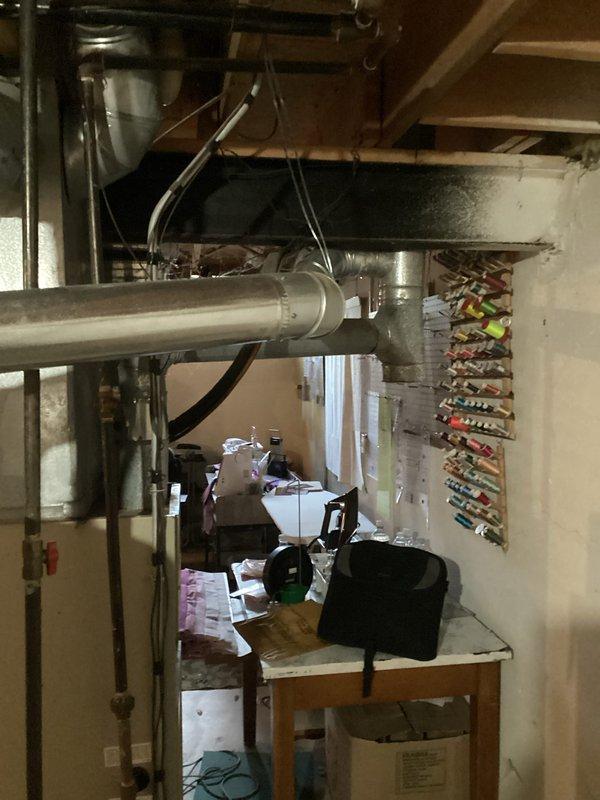 Completed comprehensive HVAC system assessment for equipment replacement in residential basement mechanical room. Evaluated existing heating system configuration, ductwork layout, and spatial requirements for new equipment installation, documenting current system components including furnace unit, metal ductwork, and associated piping infrastructure to provide accurate replacement estimate.