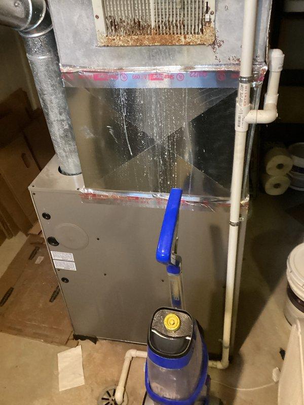 Conducted comprehensive assessment of 37-year-old original HVAC system from 1989 that has consistently underperformed since current occupancy began three years ago. Evaluated existing furnace unit in basement, outdoor condenser unit, and thermostat in living room to provide replacement estimate quotes. Documented equipment condition through photographs showing aged furnace with accumulated dust and dirt on filter grille, metal ductwork connections, PVC condensate drainage, and electrical breaker panel configuration to support recommendation for complete system replacement due to inadequate cooling performance requiring supplemental window units during warm weather.