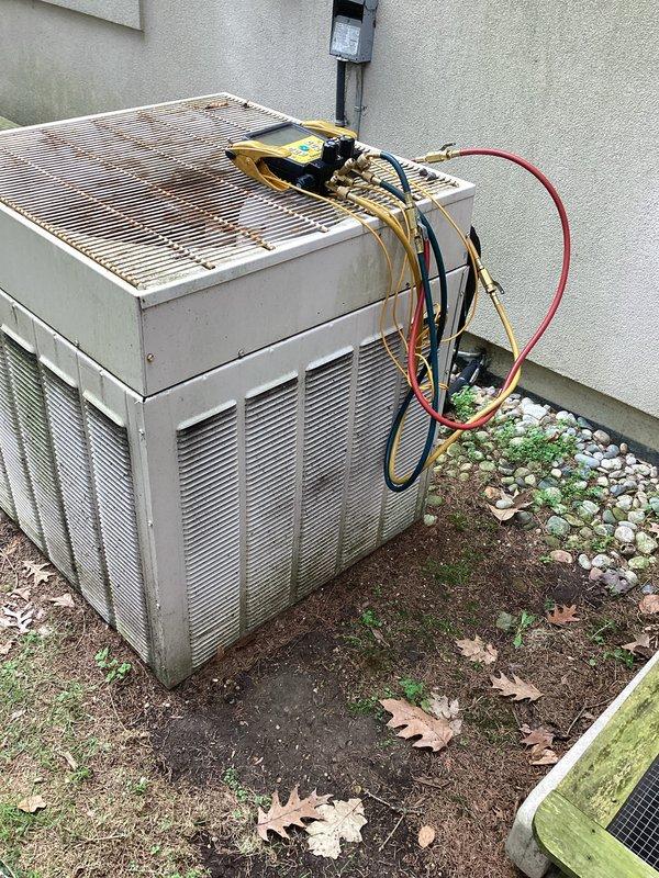 Conducted comprehensive evaluation of existing R22 residential HVAC system for replacement estimate. Assessed indoor air handler unit located in basement utility area and outdoor condensing unit positioned along exterior wall. Documented current system configuration including refrigerant line routing, electrical connections, condensate drainage, and ductwork connections. Photographed equipment conditions showing age-related wear on both indoor and outdoor components. Evaluated installation space constraints, existing infrastructure compatibility, and necessary modifications for new equipment installation. Provided detailed replacement recommendations accounting for R22 phase-out requirements and system upgrade options.