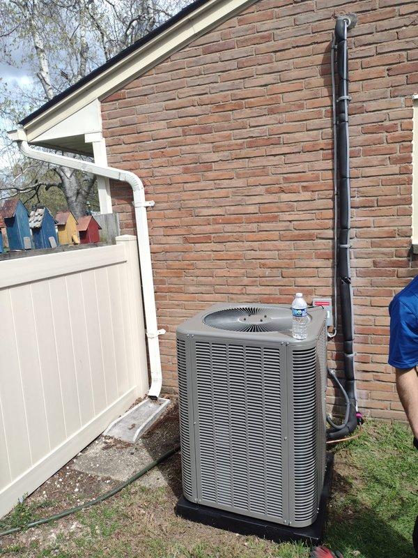 Completed full HVAC system installation including Lennox 80% efficiency downflow furnace mounted horizontally in attic space between floor joists and matching air conditioning condenser unit positioned on exterior concrete pad against brick wall. Installed all necessary refrigerant lines, condensate drain piping, flexible ductwork connections, electrical wiring, and proper mounting hardware per manufacturer specifications. System tested and operational upon completion.