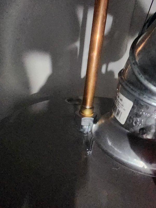 Responded to callback regarding hot water issue from refrigerator. Upon inspection, examined refrigerant lines, compressor unit, and associated plumbing connections. Verified proper installation of drain pan beneath equipment and documented current system configuration with copper tubing, flexible conduit, and wall-mounted outlet box. All components photographed for service records.