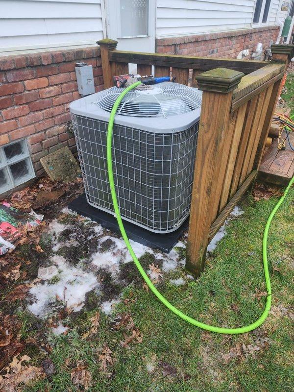 Completed scheduled prepaid maintenance tune-up on residential cooling system. Performed comprehensive inspection of outdoor condenser unit and indoor components. System found operating within normal parameters with adequate airflow and proper refrigerant pressures. Inspected compressor assembly, refrigerant line connections, and insulation integrity—all components in satisfactory condition. Noted condensate drainage functioning properly with moisture present in drain pan as expected during normal operation. Outdoor unit positioned on concrete pad with wooden privacy enclosure showing typical weathering. System tested and confirmed operational at time of service completion.