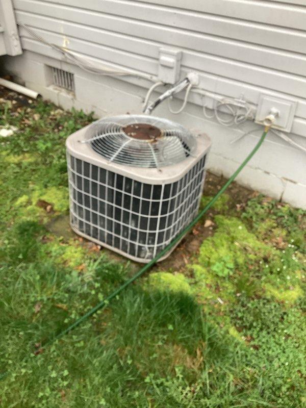 Provided estimate for replacement of aging outdoor air conditioning condenser unit located in backyard. Current system operational but experiencing intermittent shutoff issues. Assessed existing equipment condition, documented weathered tan-colored condenser with visible wear, and evaluated indoor air handler components housed in utility closet to determine complete system replacement specifications.