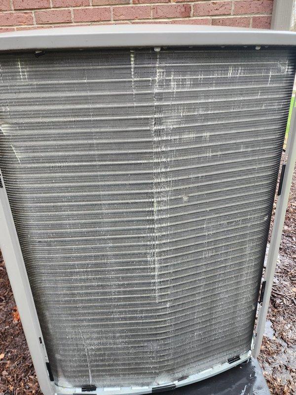 # A/C Maintenance Completed

Performed comprehensive preventive maintenance on residential split-system air conditioning unit. Inspected outdoor condensing unit and identified moderate mineral deposit buildup with white vertical streaking on condenser coil fins, indicating previous refrigerant leak or excessive condensate drainage patterns. Condenser coil fins remained structurally intact with proper spacing maintained throughout.

Accessed indoor air handler and inspected evaporator coil assembly and drain pan system. Noted significant staining and discoloration in condensate drain pan with rust-colored deposits indicating long-term moisture accumulation and possible microbial growth. Observed oxidation on copper refrigerant line sets consistent with normal aging. Verified condensate pump operation and confirmed proper drainage function. Reflective insulation liner showed acceptable condition with no significant deterioration.

Cleaned condenser coil exterior surfaces to remove dirt a