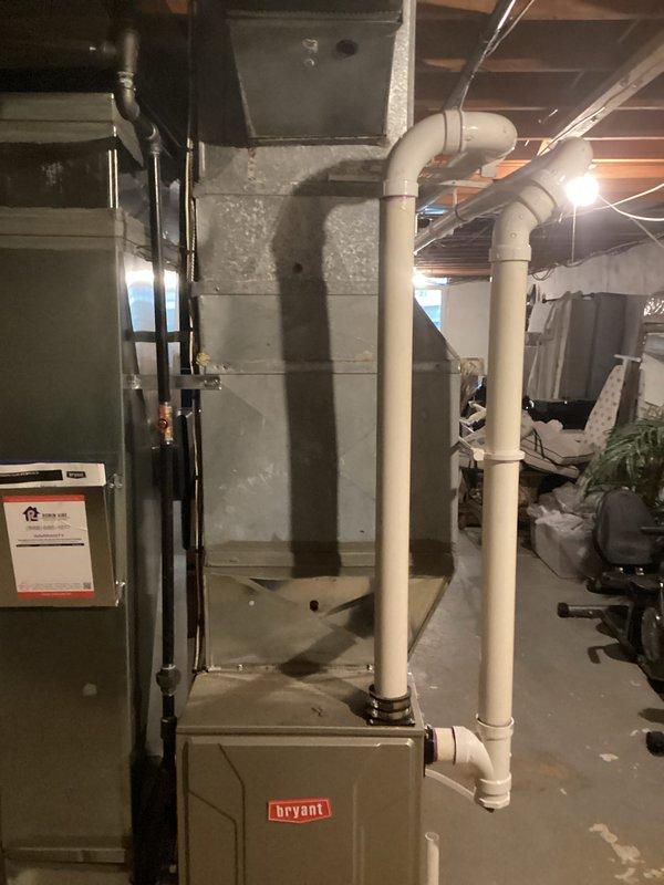 Completed estimate for air conditioning system replacement due to low R-22 refrigerant levels in existing unit. Assessed current basement installation consisting of Bryant furnace and older air handler with refrigerant lines, noting R-22 phase-out requiring full system replacement rather than recharge. Documented existing HVAC configuration including ductwork connections, PVC condensate drainage, and electrical connections to provide accurate replacement specifications and equipment recommendations.