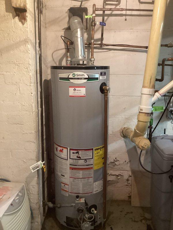 Provided comprehensive estimate for hot water heater replacement in residential basement utility area. Evaluated existing A.O. Smith water heater installation, including current plumbing configuration with copper and PEX connections, flue venting system, and adjacent water treatment equipment. Assessed utility space layout, existing infrastructure connections, and determined scope of work required for complete unit replacement while maintaining proper venting, code-compliant installation, and integration with existing water filtration system.