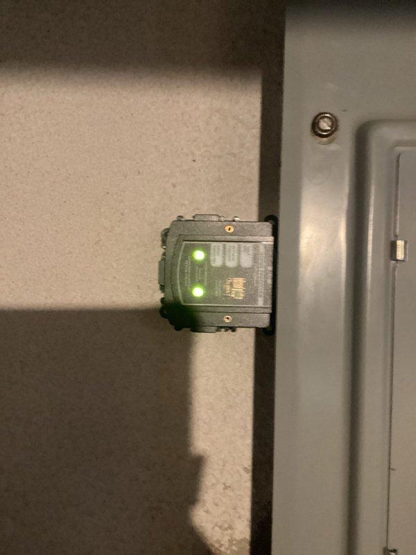 Installed whole-home surge suppressor device on main electrical service panel to protect household circuits and appliances from voltage spikes. Device was properly mounted adjacent to the 32-circuit main breaker panel, connected per manufacturer specifications, and tested to confirm operational status with green indicator lights illuminated.