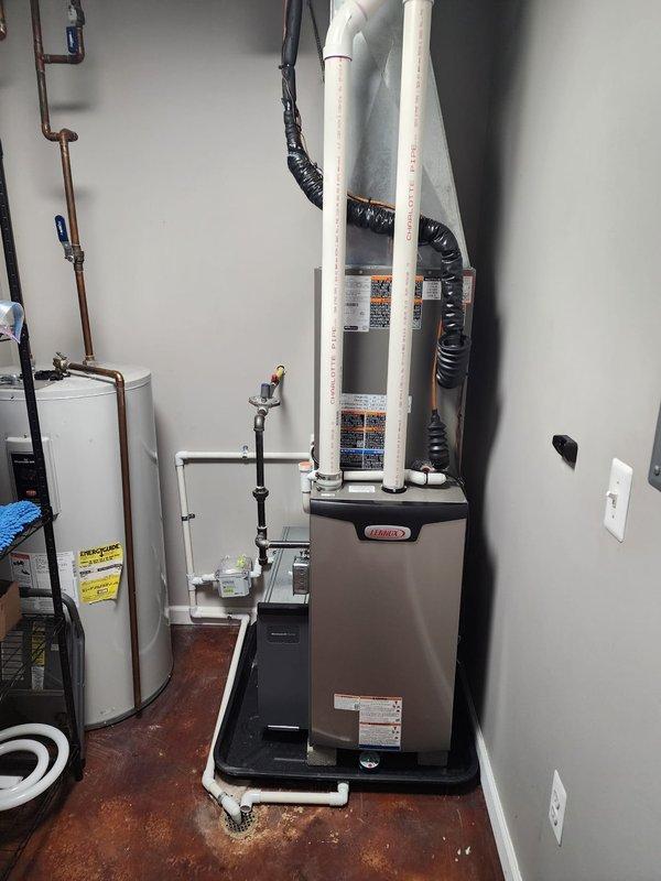 Completed full HVAC system installation including Lennox furnace, air conditioning unit, and S40 smart thermostat in residential utility room. Installed furnace on protective drain pan with proper PVC venting configuration, integrated air filtration cabinet with pleated filter assembly, and connected all necessary ductwork including flexible metallic and insulated black piping. Mounted thermostat, ran electrical connections, sealed all roof penetrations from screw and nail holes per specifications, verified proper drainage, and tested system operation to ensure full functionality.