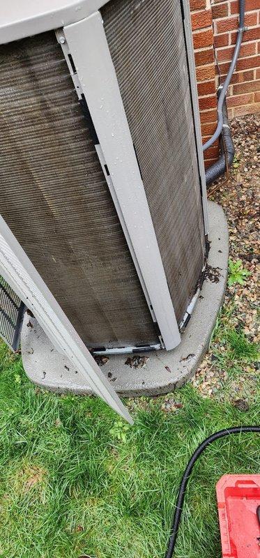 Completed scheduled preventative maintenance on residential Lennox air conditioning system. Upon arrival, found outdoor condenser unit with heavily soiled coil fins exhibiting significant accumulation of dirt, debris, and organic matter causing reduced airflow efficiency. Opened access panel and thoroughly cleaned condenser coils to restore proper heat transfer capability. Inspected electrical connections at disconnect box and verified secure mounting. Removed leaf litter and debris from concrete pad surrounding unit. System operational and running within normal parameters upon completion of maintenance service.