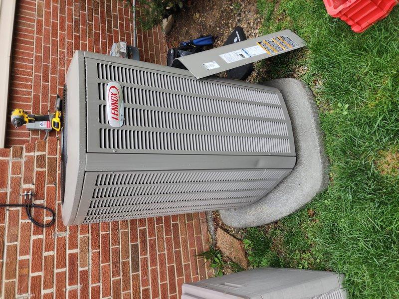 Completed scheduled preventative maintenance on residential Lennox air conditioning system. Upon arrival, found outdoor condenser unit with heavily soiled coil fins exhibiting significant accumulation of dirt, debris, and organic matter causing reduced airflow efficiency. Opened access panel and thoroughly cleaned condenser coils to restore proper heat transfer capability. Inspected electrical connections at disconnect box and verified secure mounting. Removed leaf litter and debris from concrete pad surrounding unit. System operational and running within normal parameters upon completion of maintenance service.
