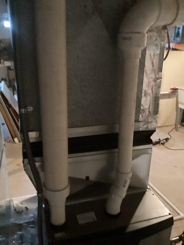 Completed HVAC system replacement estimate for residential property with existing air conditioning unit low on R-22 refrigerant. Assessed outdoor condenser unit and indoor equipment installation in basement utility area, documenting current system configuration including PVC drain and vent lines, electrical connections at exterior meter location, and equipment positioning. Provided comprehensive replacement options for aging R-22 system to address refrigerant availability concerns and improve system efficiency.