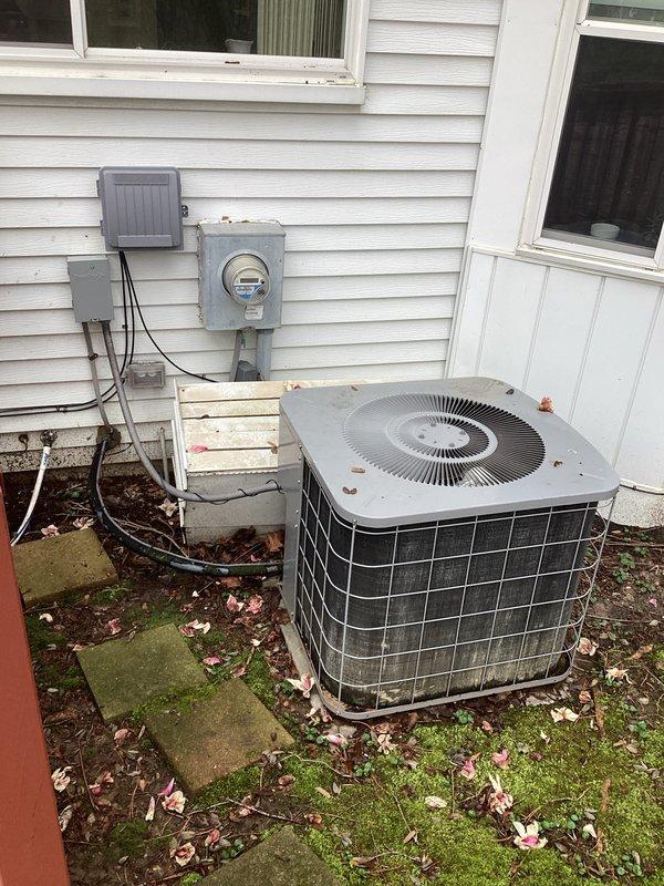 Completed HVAC system replacement estimate for residential property with existing air conditioning unit low on R-22 refrigerant. Assessed outdoor condenser unit and indoor equipment installation in basement utility area, documenting current system configuration including PVC drain and vent lines, electrical connections at exterior meter location, and equipment positioning. Provided comprehensive replacement options for aging R-22 system to address refrigerant availability concerns and improve system efficiency.