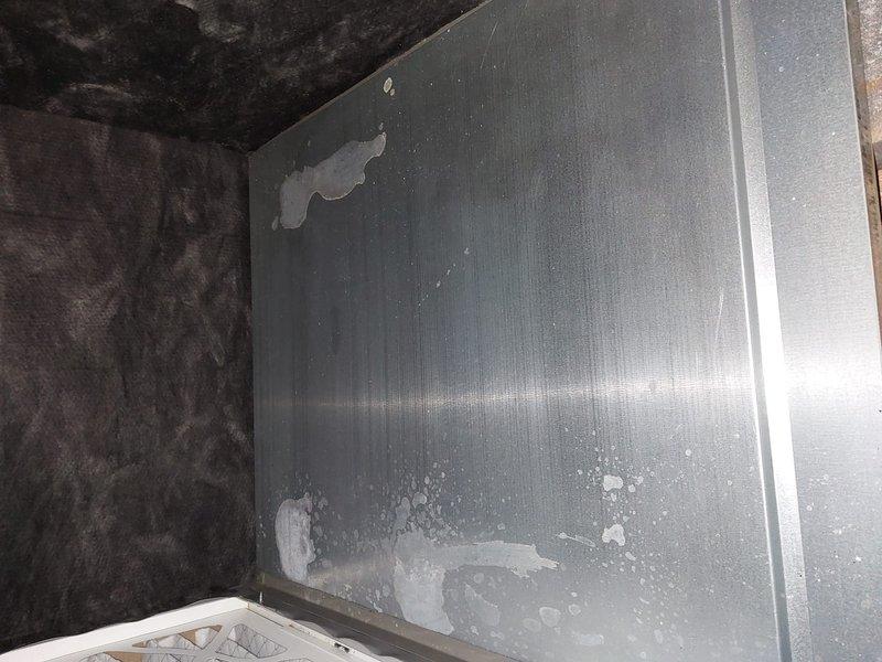 Completed scheduled heating maintenance on furnace unit located in attic space. Performed standard preventive maintenance inspection including visual assessment of equipment condition and accessibility. Unit operational at time of service. Documentation photos captured showing metal cabinet surface with moisture accumulation, mineral deposits, and coating deterioration on exterior panels, with equipment positioned in insulated attic environment.