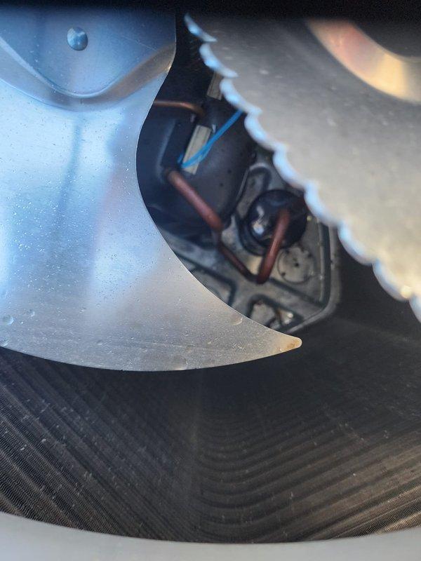 Completed routine maintenance on residential air conditioning system. Inspected outdoor condenser unit, noting significant dirt and debris accumulation on coil fins requiring cleaning for optimal heat transfer efficiency. Examined internal components including condenser fan motor, blades, and electrical connections, verifying proper operation and mechanical integrity of all accessible parts.