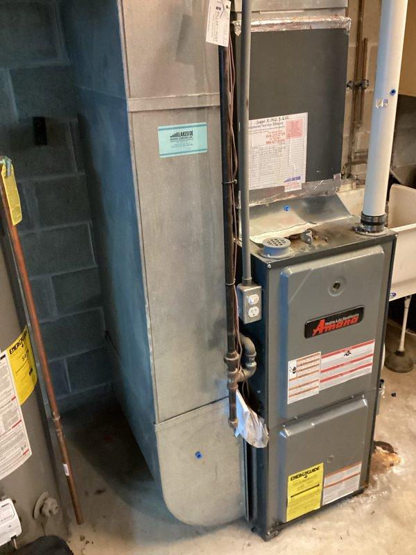 Completed furnace replacement estimate for 15-year-old Amana unit located in basement mechanical room. Documented existing equipment configuration including furnace, ductwork, electrical panel, copper and PVC piping connections, and surrounding utility infrastructure to provide accurate replacement system specifications and installation requirements.