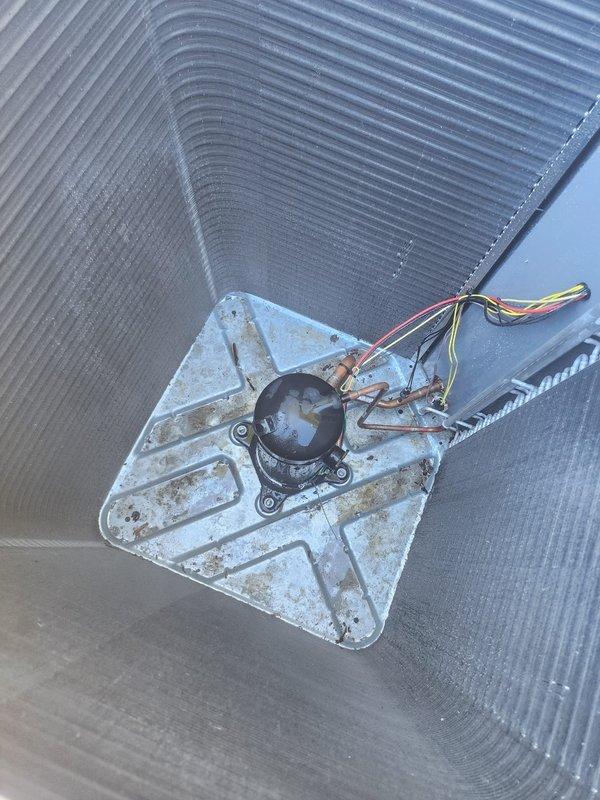 Completed scheduled prepaid maintenance tune-up on residential cooling system. Performed comprehensive inspection of outdoor condenser unit and indoor evaporator coil assembly. System found operating within normal parameters with no immediate service needs identified. Documented equipment condition through photographic records showing evaporator coil with diamond plate heat exchanger, blower motor assembly with electrical connections intact, and exterior condenser unit positioned against building foundation. All components inspected and confirmed in working order for continued operation through the 2025 cooling season.