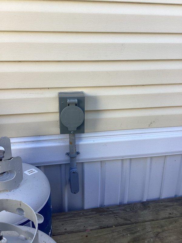 Installed mechanical interlock kit on main electrical panel and mounted 30-amp power inlet box on exterior wall to enable safe backup generator connection during utility outages. Replaced standard breakers with tandem breakers to accommodate new generator backfeed breaker, installed exterior-rated cable routed through crawlspace to inlet location near shed area, and verified proper interlock operation to prevent backfeeding utility lines.