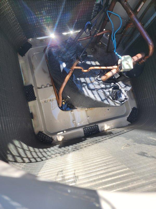 Completed routine maintenance on residential air conditioning system. Inspected indoor air handler unit, verifying condensate drain pan condition and proper placement on isolation pads. Examined refrigerant line connections and insulation integrity. Inspected outdoor condenser unit, noting clean coil fins and proper ventilation grille condition with no obstructions or damage present.