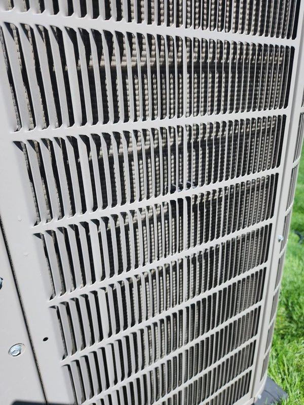 Completed routine maintenance on residential air conditioning system. Inspected indoor air handler unit, verifying condensate drain pan condition and proper placement on isolation pads. Examined refrigerant line connections and insulation integrity. Inspected outdoor condenser unit, noting clean coil fins and proper ventilation grille condition with no obstructions or damage present.