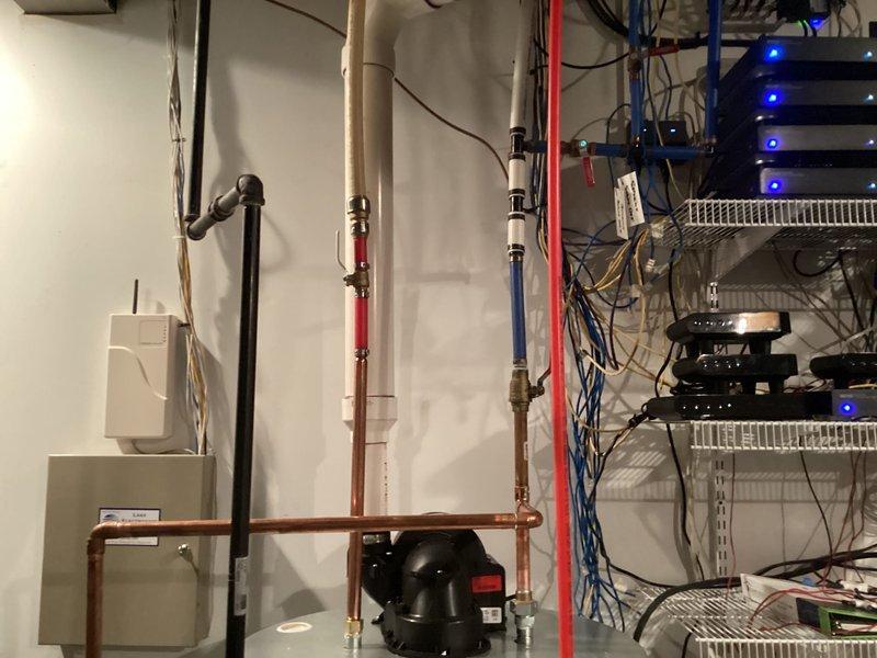 Completed installation of 75-gallon power vent tank-type water heater in basement utility area. Installation included connecting hot and cold water supply lines using PEX and copper piping, installing blue expansion tank for thermal expansion protection, and routing power vent exhaust system. All plumbing connections were properly secured with appropriate fittings, and the unit was tested for proper operation and leak-free performance upon completion.