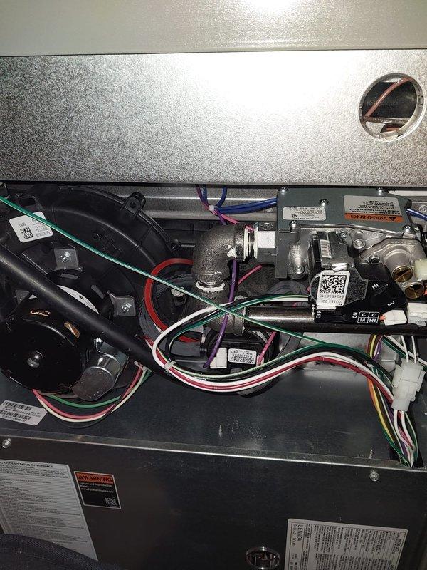 Completed scheduled furnace maintenance on dual-system heating equipment as part of Worry Free Service Agreement. Performed comprehensive inspection of internal components including blower motor assembly, electrical connections, control modules, and wiring harnesses; verified all safety labels and operational specifications; documented system condition with photographs showing proper component arrangement and secure wire routing throughout both units.