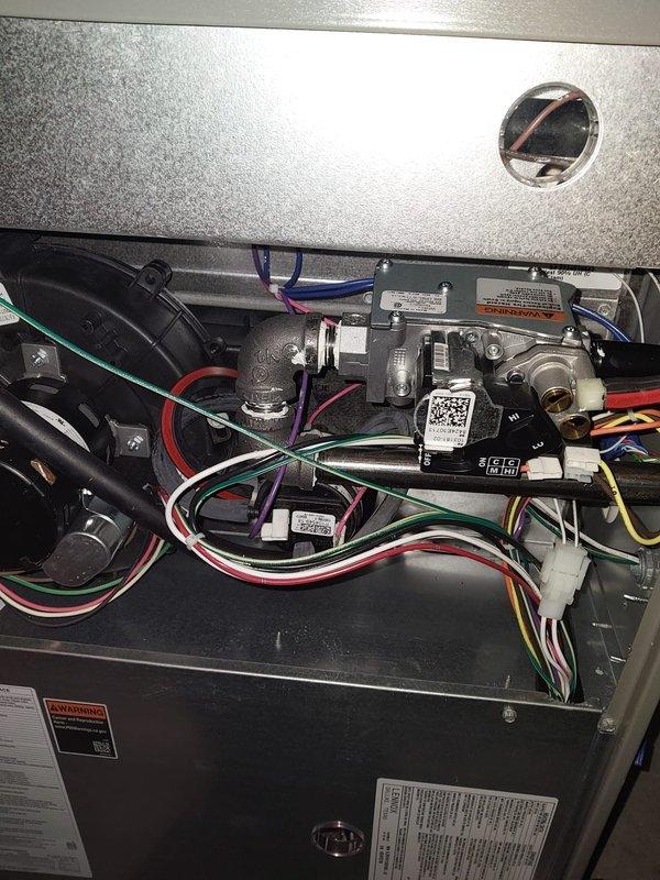 Completed scheduled furnace maintenance on dual-system heating equipment as part of Worry Free Service Agreement. Performed comprehensive inspection of internal components including blower motor assembly, electrical connections, control modules, and wiring harnesses; verified all safety labels and operational specifications; documented system condition with photographs showing proper component arrangement and secure wire routing throughout both units.