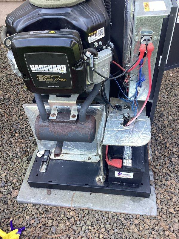 Performed scheduled maintenance on Vanguard 627cc generator unit. Removed and inspected spark plugs, finding moderate carbon buildup and electrode wear consistent with normal operation. Replaced both spark plugs with new components to manufacturer specifications. Conducted visual inspection of engine housing, electrical connections, and associated components including accumulator tank and control systems. Verified proper wire routing and connection integrity on power supply lines. Cleaned debris from equipment surfaces and surrounding area. Unit tested successfully following service completion.
