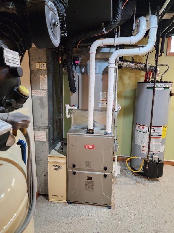 Completed installation of Bryant furnace system with T6 programmable thermostat and new chimney liner. All equipment installed to manufacturer specifications with proper venting, gas connections, electrical wiring, and condensate drainage system configured for optimal performance and safety compliance.