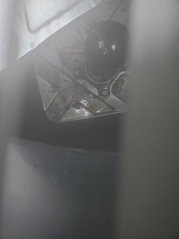 Completed routine preventative maintenance on residential air conditioning system. Inspected outdoor condenser unit, noting minor dirt accumulation on coil fins but overall functional condition. Examined indoor components including mounting brackets and mechanical assemblies, observing normal condensation present on cold surfaces indicating proper system operation. Unit operating within normal parameters with no immediate repairs required.