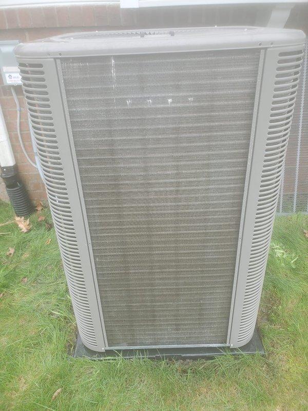 Completed routine preventative maintenance on residential air conditioning system. Inspected outdoor condenser unit, noting minor dirt accumulation on coil fins but overall functional condition. Examined indoor components including mounting brackets and mechanical assemblies, observing normal condensation present on cold surfaces indicating proper system operation. Unit operating within normal parameters with no immediate repairs required.