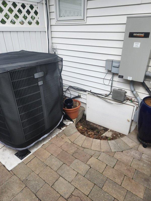 Responded to service call for high electrical bills with heat pump running continuously. Performed system inspection of outdoor heat pump unit and associated electrical components. Documented existing equipment configuration including outdoor condenser unit, electrical disconnect, and backup generator system. Unit accessibility and exterior connections were photographed for service records.