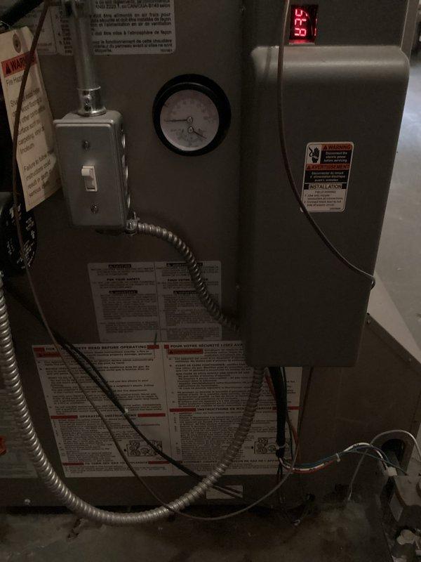 Responded to service call for boiler leaking water. Upon inspection, identified active leak in heating system piping connections. Examined circulator pump assembly and associated copper piping showing oxidation and age-related wear. Tightened compromised fittings and connections where seepage was occurring. Verified system pressure gauge readings and monitored digital temperature display showing 43°F. Tested system operation after repairs to confirm leak was resolved and all connections were secure with no further water discharge.