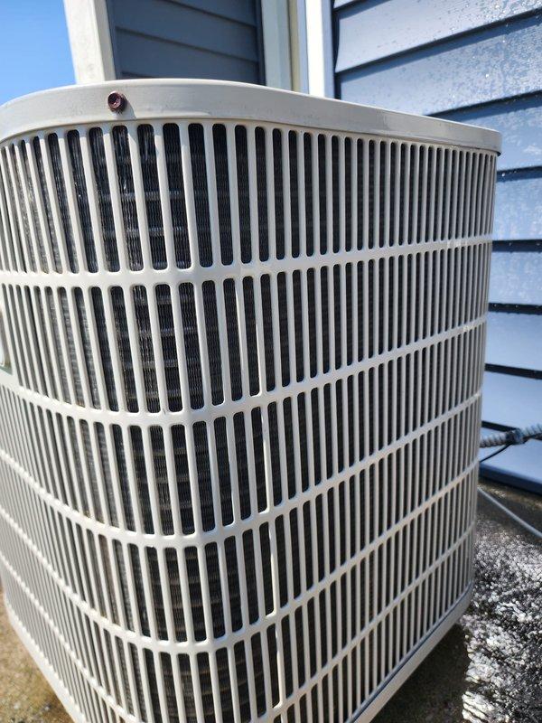 # HVAC Cooling System Maintenance Completed

Performed comprehensive preventative maintenance on residential outdoor air conditioning condenser unit. System was confirmed operational upon arrival. Conducted visual inspection of exterior housing, protective grille, and mounting pad—all components showed normal wear with no signs of damage, rust, or deterioration. Removed top panel to access internal components for detailed inspection.

Examined compressor, condenser coil, and refrigerant lines. Compressor in good working condition with proper mounting. Inspected copper refrigerant lines for leaks, damage, or loose connections—all secure and intact. Evaluated condenser coil fins for debris accumulation and airflow obstruction; coils displayed typical outdoor weathering but maintained adequate condition for efficient operation. Checked electrical connections and control compartment for proper function.

Verified unit operation and system performance. All components functioning within norm