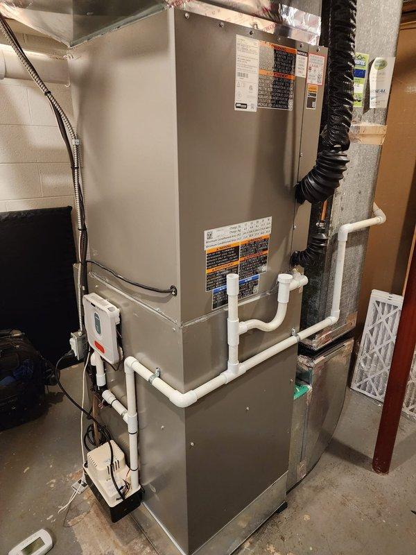 Completed installation of Lennox air conditioning system including new air handler unit and Honeywell THM5320R thermostat. System was installed, tested, and verified operational with proper condensate drainage lines and electrical connections in place.