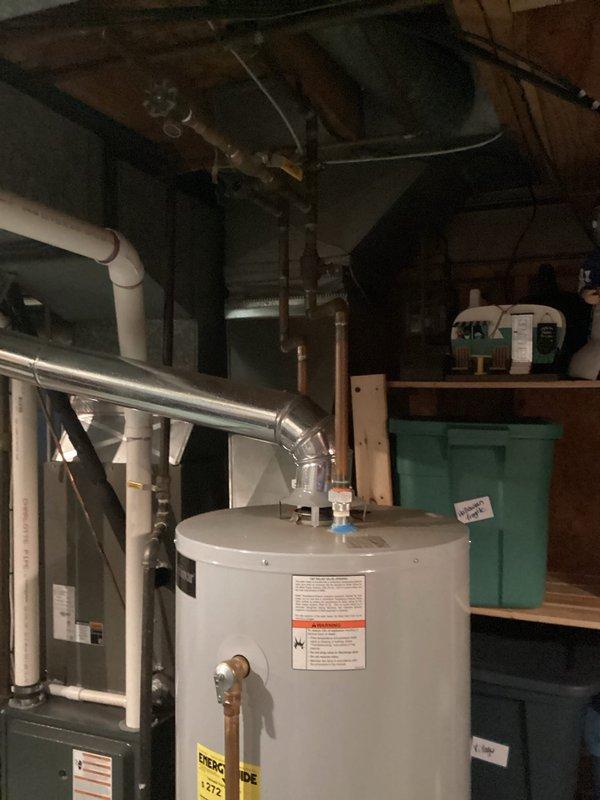 Responded to emergency water heater failure that resulted in complete tank discharge flooding the basement. Conducted on-site assessment of the failed unit, documented existing installation including venting configuration and plumbing connections, and photographed the water heater and surrounding mechanical equipment. Provided comprehensive quote for water heater replacement including removal of failed unit and installation of new system with proper venting and code-compliant connections.