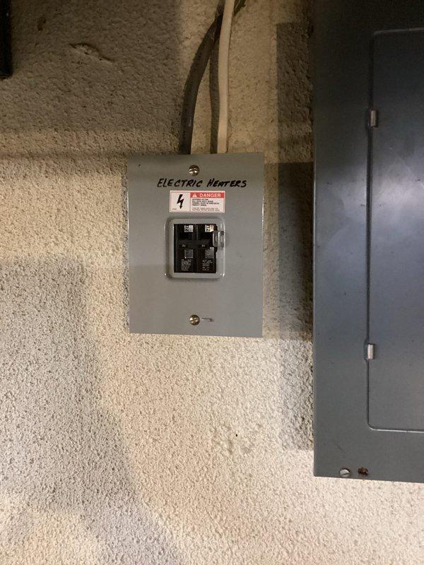 Conducted on-site estimate for mini-split installation in residential property. Evaluated interior living space layout and existing electrical infrastructure, including current disconnect box labeled for electric heaters, to determine optimal placement and electrical requirements for new ductless heat pump system.