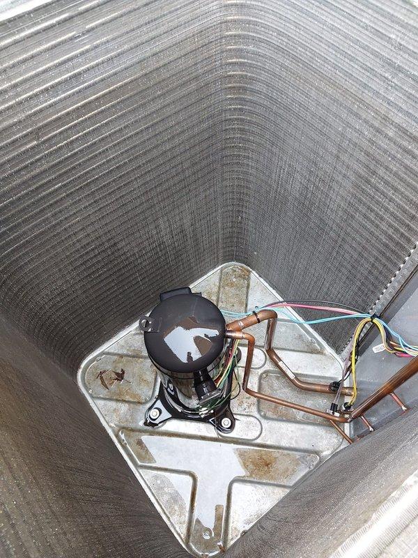 Completed seasonal cooling maintenance and tune-up on residential split-system air conditioning unit. System was operational upon arrival and confirmed working properly throughout service. Performed comprehensive inspection of outdoor condenser unit, including examination of aluminum fin condition, refrigerant line connections, and electrical components. Documented moderate surface rust and corrosion present on interior base pan, though not affecting current system operation. Verified compressor function, refrigerant line integrity, and proper electrical connections. System left in good working order with seasonal maintenance completed per prepaid service agreement.