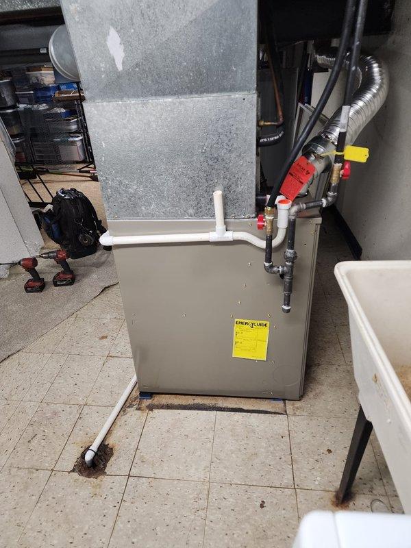 Successfully installed a new Bryant 80% efficiency gas furnace in the basement utility area, replacing the existing heating unit. The installation included proper connection of all ductwork, PVC venting through the exterior wall, condensate pump assembly with drain lines, and gas line hookup. Per customer request, the existing return air filter grille and whole-house humidifier were retained and integrated with the new furnace system to maintain current air quality features while upgrading the primary heating equipment.