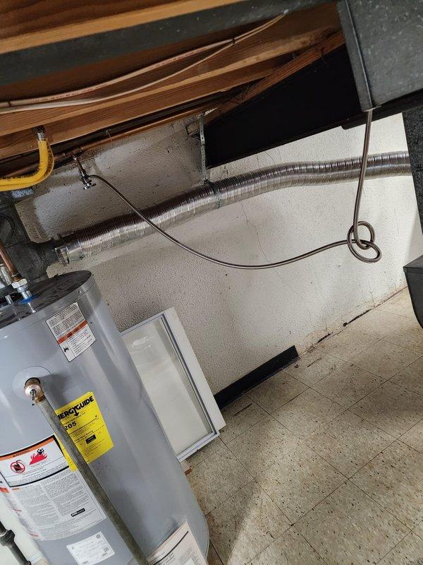 Successfully installed a new Bryant 80% efficiency gas furnace in the basement utility area, replacing the existing heating unit. The installation included proper connection of all ductwork, PVC venting through the exterior wall, condensate pump assembly with drain lines, and gas line hookup. Per customer request, the existing return air filter grille and whole-house humidifier were retained and integrated with the new furnace system to maintain current air quality features while upgrading the primary heating equipment.