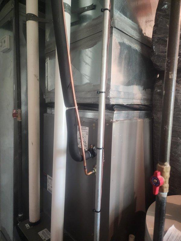 Responded to callback for failed inspection corrections on HVAC installation. Repaired damaged flexible canvas connector on supply ductwork that had been compressed during initial installation. Documented completed repairs with photographs showing furnace unit, vertical ductwork, copper refrigerant lines, and corrected canvas connection. Submitted follow-up documentation for reinspection scheduling.