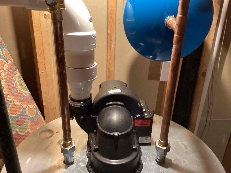 Completed installation of a 75-gallon tanked water heater in unfinished basement utility area. Connected all necessary copper supply lines and PVC piping, installed circulation pump with proper mounting and hose clamps, and integrated blue expansion tank to system for proper pressure regulation. All components installed per manufacturer specifications with appropriate Teflon tape application, venting assembly secured, and system tested for proper operation and leak-free connections.
