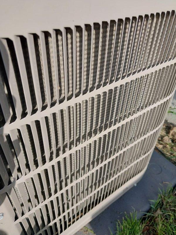 Completed preventive maintenance inspection on residential air conditioning system under Worry Free Service Agreement coverage. Inspected outdoor condenser unit exterior grille, verified proper airflow through louvered panels, and examined indoor air handler components including insulated ductwork, refrigerant lines, and electrical connections. All AC system components found operating within normal parameters with routine dust accumulation noted and equipment confirmed in good working condition.