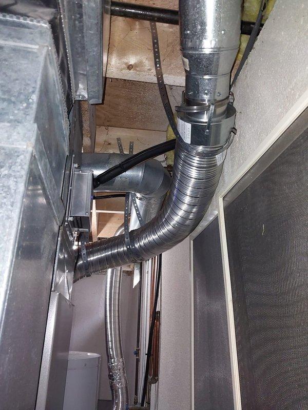 Responded to service call for leaking tanked water heater. Upon inspection, discovered significant rust corrosion and moisture accumulation at the base of the unit, particularly around the drain pan area and plastic component housing. Heavy rust deposits and deteriorated material indicated prolonged water exposure and compromised structural integrity of the tank base. Documented extensive corrosion damage affecting the water heater's lower collection area and surrounding metal surfaces. Assessed unit condition and photographed damage for service records.