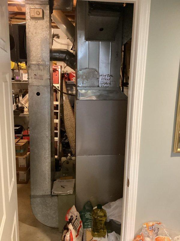 Provided estimate for complete replacement of 15-year-old air conditioning and furnace system located in basement mechanical room. Current air conditioning unit is non-operational while furnace remains functional. Assessed existing natural gas furnace installation and accompanying ductwork system, including horizontal main trunk line with elbow joint and vertical connections, to determine specifications for replacement equipment and compatibility with current infrastructure.