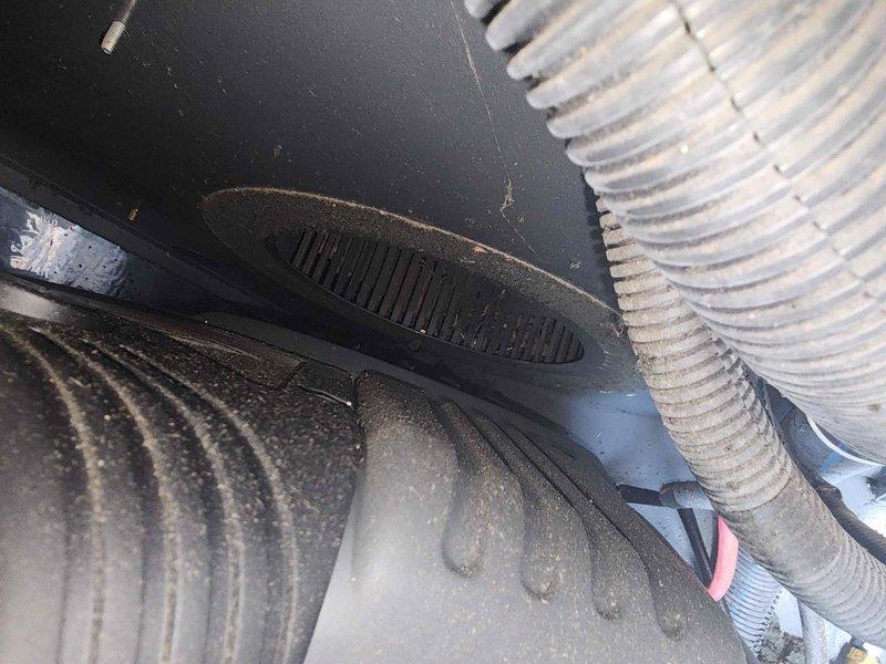 Performed scheduled generator maintenance including inspection of unit components and hardware. Removed and inspected mounting fasteners, verified secure installation of all mechanical connections. Examined HVAC system integration with generator setup, noting International Comfort brand equipment. Cleaned accumulated debris and dust from corrugated coil surfaces and surrounding components. Inspected flexible ductwork connections and verified proper seating of all ventilation attachments. Confirmed all hardware reinstalled properly and system ready for operation.