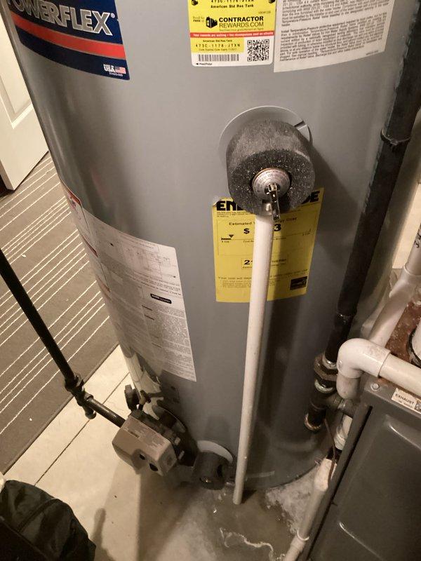 Conducted on-site assessment of 10-year-old PowerFlex residential water heater experiencing active leakage in basement utility area. Documented existing unit configuration including PVC discharge piping, pressure relief valve assembly, and standard plumbing connections. Photographed installation conditions, surrounding mechanical systems, and evidence of water accumulation at base to provide comprehensive estimate for complete water heater replacement.