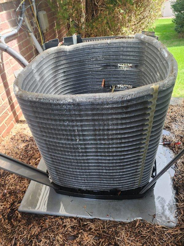 Completed routine preventative maintenance on residential air conditioning system. Performed comprehensive inspection of outdoor condenser unit and indoor evaporator coil assembly, documenting equipment condition with photos. Condenser coils showed moderate accumulation of dirt, dust, and organic debris between fins from outdoor exposure. Evaporator coil exhibited dust buildup on outer fin sections with cleaner appearance toward center. Verified refrigerant lines, electrical connections, and mechanical components during inspection. System operational at time of service completion.