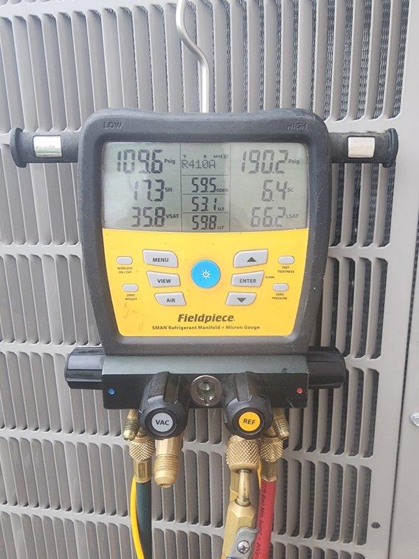 Completed scheduled air conditioning maintenance on residential cooling system. Performed refrigerant pressure and temperature diagnostics using digital manifold gauges, verifying proper system charge and operating parameters on the outdoor condensing unit. All readings within manufacturer specifications, condenser coils and protective grille inspected and found in satisfactory condition.
