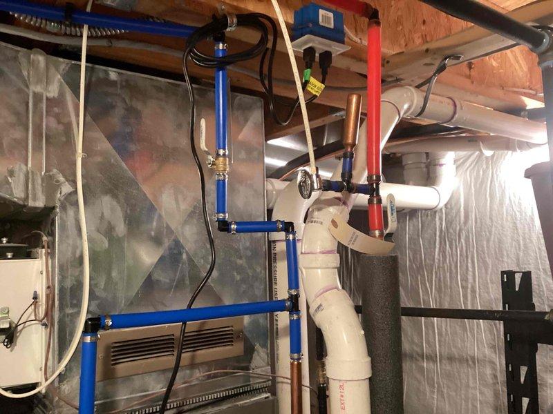 Completed installation of a 50-gallon tanked water heater in basement mechanical room. Established all necessary water supply connections using blue PEX piping and copper lines, installed pressure tank, and integrated new unit with existing plumbing infrastructure. System was tested, verified operational, and customer payment was collected upon completion.