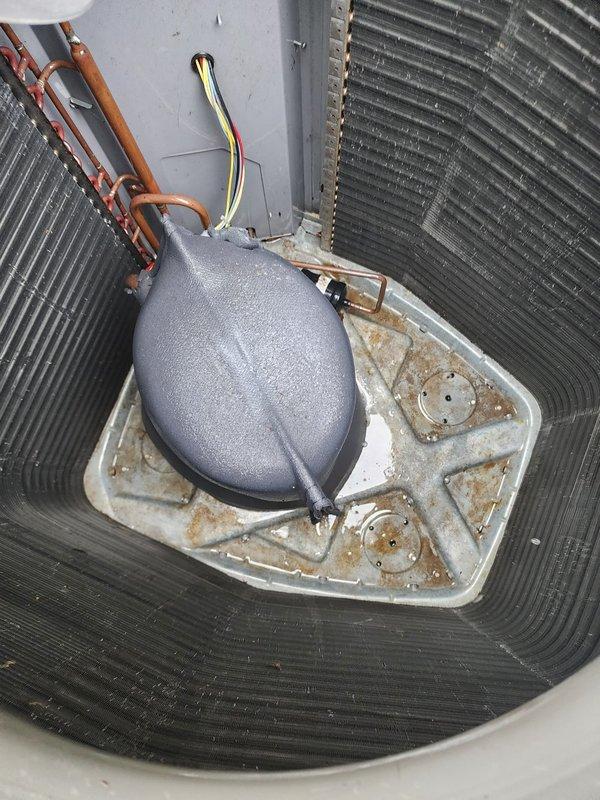 Completed comprehensive cooling system maintenance and tune-up on residential air conditioning unit. Performed standard preventive maintenance procedures including inspection of outdoor condenser unit, which showed accumulated debris between fins and weathering consistent with outdoor exposure. Cleaned condenser coils to restore optimal airflow and heat transfer efficiency. Inspected indoor evaporator coil assembly and accumulator component, noting rust staining on drain pan indicating historical moisture accumulation. Verified all refrigerant line connections, electrical wiring, and system components were secure and functioning properly. System tested and confirmed operational with no performance issues identified at time of service.